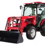 Mahindra 2638 HST tractor with cab and bucket loader attachment.