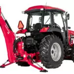 Mahindra 6075 utility tractor with cab and backhoe attachment.