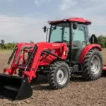 Mahindra 2670 with cab in open field.