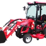 side of Mahindra eMax20S HST cab sub-compact tractor with bucket attachment: cab door open.