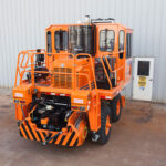 Rail King RK330 G6 railcar mover parked right outside a facility building.