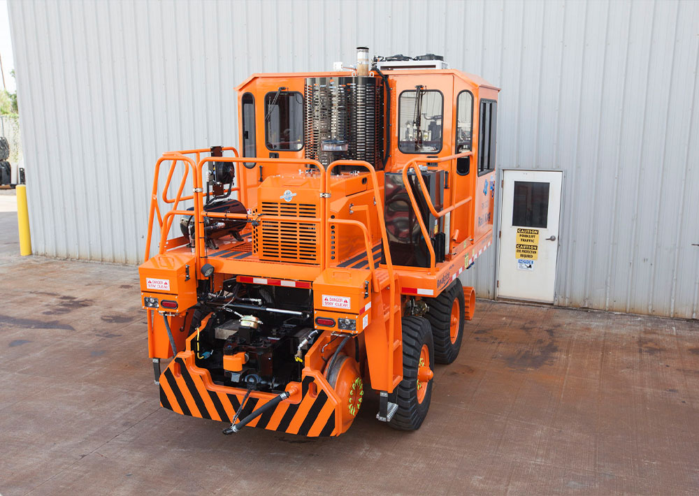 Rail King RK330 G6 railcar mover parked right outside a facility building.