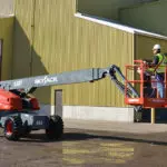 Skyjack SJ66 T+ telescopic boom with operator in work area.
