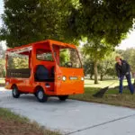 Taylor-Dunn Bigfoot Burden Carrier Utility Vehicle outdoors.