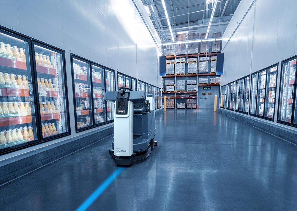 Advance Liberty SC60 autonomous floor cleaner scrubbing grocery aisle floors.