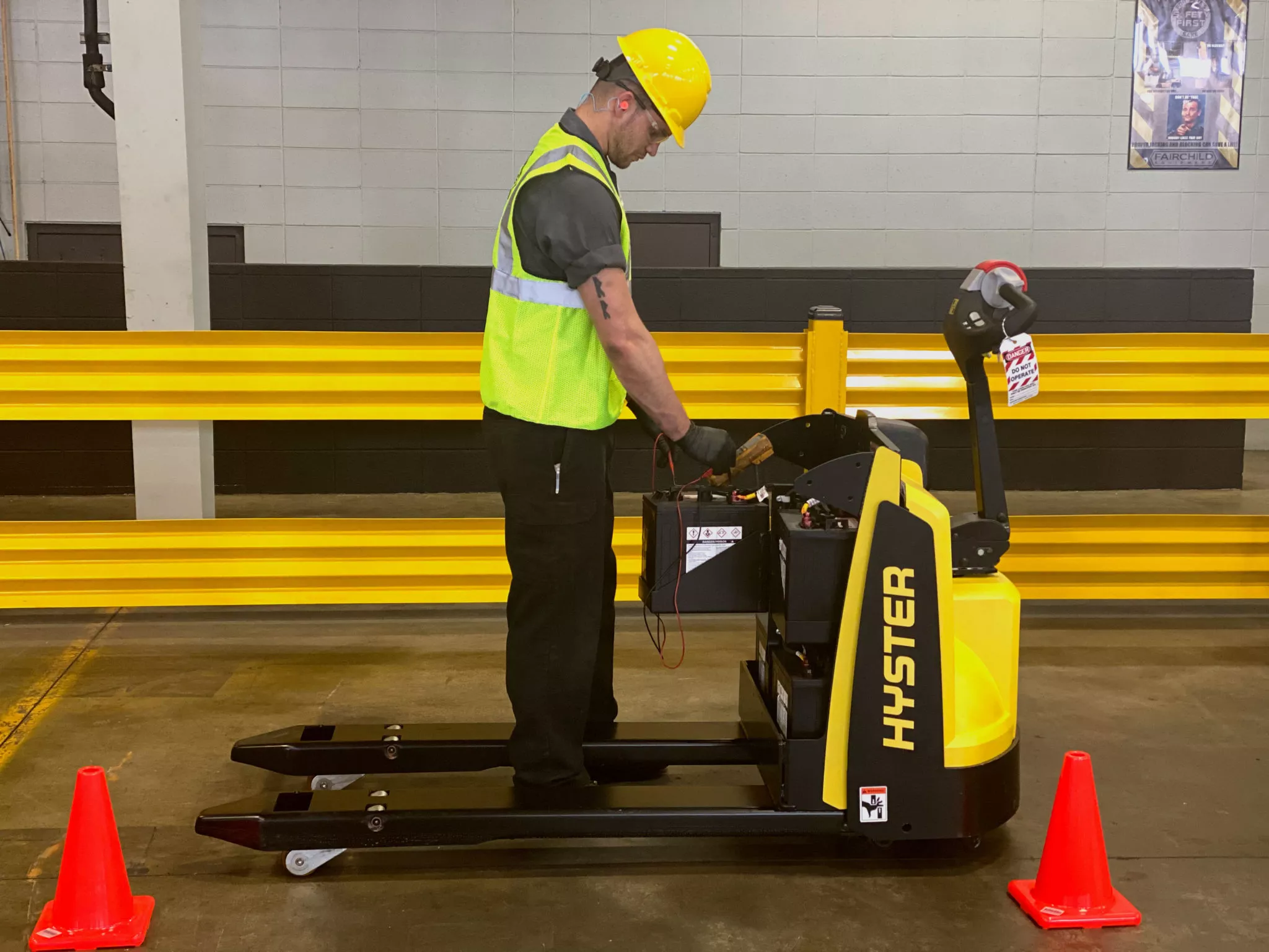 technician performing preventative maintenance on a hyster walkie pallet truck.