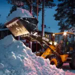 JCB 409 Wheel Loader construction and agriculture truck scooping and plowing snow.