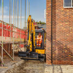 JCB 35z-1 compact excavator in action at construction site.