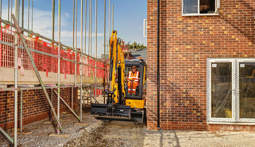 JCB 35z-1 compact excavator in action at construction site.