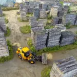 JCB 427 Wheel Loader construction and agriculture truck navigating work site carrying materials.