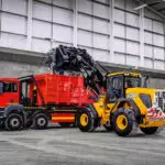 JCB 437 Wheel Loader construction and agriculture truck dumping materials into dump truck.