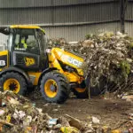 JCB TM-220 articulated telescopic handler carrying material.