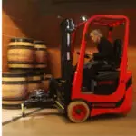 Mariotti MX 16 Turret electric 3 wheel forklift in action in warehouse.