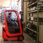 Mariotti MYCROS AC RWD 13 Forklift with mast up in warehouse, side view.