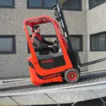 Mariotti Mycros AC 13 forklift driving up a ramp.