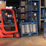 Mariotti MYCROS AC RWD 13 Forklift carrying goods in warehouse, side view.
