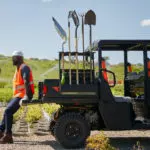 Pro XD Mid-Size Gas Crew Utility Vehicle by Polaris Commercial with man sitting on bed.