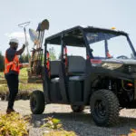 tools being loaded onto Pro XD Mid-Size Gas Crew Utility Vehicle by Polaris Commercial.