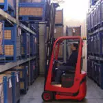 Mariotti MYCROS AC RWD 10C Forklift grabbing pallet in warehouse.