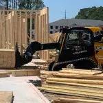 JCB 3TS-8T Teleskid transporting pallet of lumber.