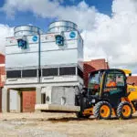 JCB 215 Skid Steer transporting concrete materials.