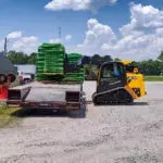 JCB 2TS-7T placing pallet of materials on a truck trailer.