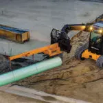 JCB 3TS-8T lifting large pipe with attachment.
