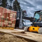 JCB 3TS-8T teleskid transporting pallet of bricks.
