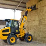 JCB TM-220 articulated telescopic handler lifting hay.
