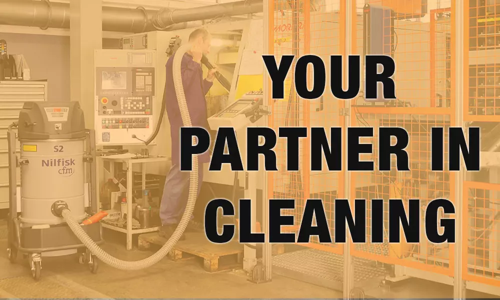 Your partner in cleaning: operator cleaning work area with Nilfisk Advance S2 industrial vacuum.