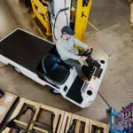 Taylor-Dunn Bigfoot S driving through tight warehouse corner.