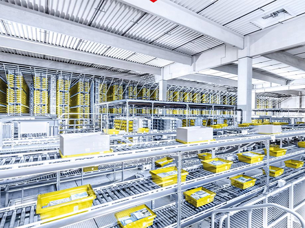Automated conveyors with bins in warehouse facility.