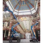 Genie Z-45 FE Boom lifts lifting operators to hang decorations outdoors.