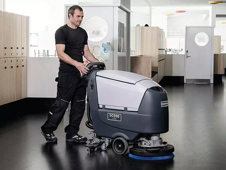Advance SC500 walk-behind scruber cleaning indoor facilities floors.