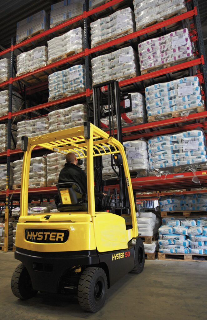Hyster J45-70XN forklift grabbing pallet off warehouse shelf.