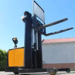 Task forklifts PYTHON straddle stacker outdoors, side mast view.