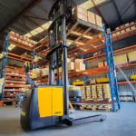 TASK Viper reach truck transporting pallet of boxes inside warehouse.