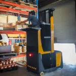 TASK Sidewinder lifting operator to place a box on a shelf.