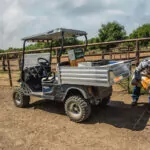 Cushman Hauler 1200X utility vehicle with materials in cargo bed.