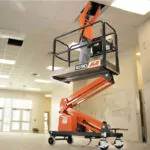 JLG 1030P vertical lift raising worker to provide ceiling maintenance.