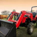 Mahindra 4540 4WD Tractor with bucket attachment on cow farm.