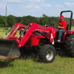 Mahindra 4540 4WD Tractor with bucket loader attachment in grass field.
