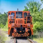 Rail King RK460 G7 mobile railcar mover driving away on tracks.