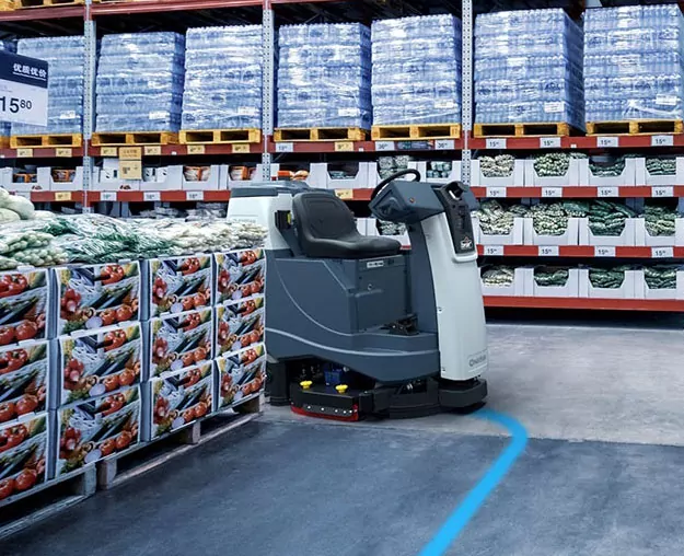 Advance Liberty SC60 autonomous floor cleaner cleaning warehouse floors.