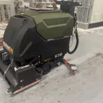 Kodiak K19 cylindrical floor scrubber in garage.