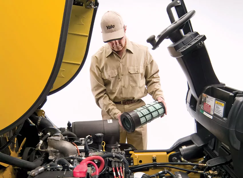 Technician repairing Yale forklift.
