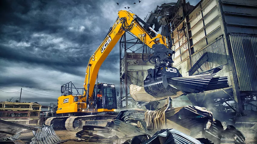 JCB excavator lifting materials on construction site.