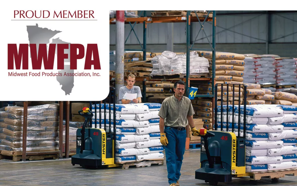 Hyster walkie pallet trucks in a food warehouse with MWFPA logo.