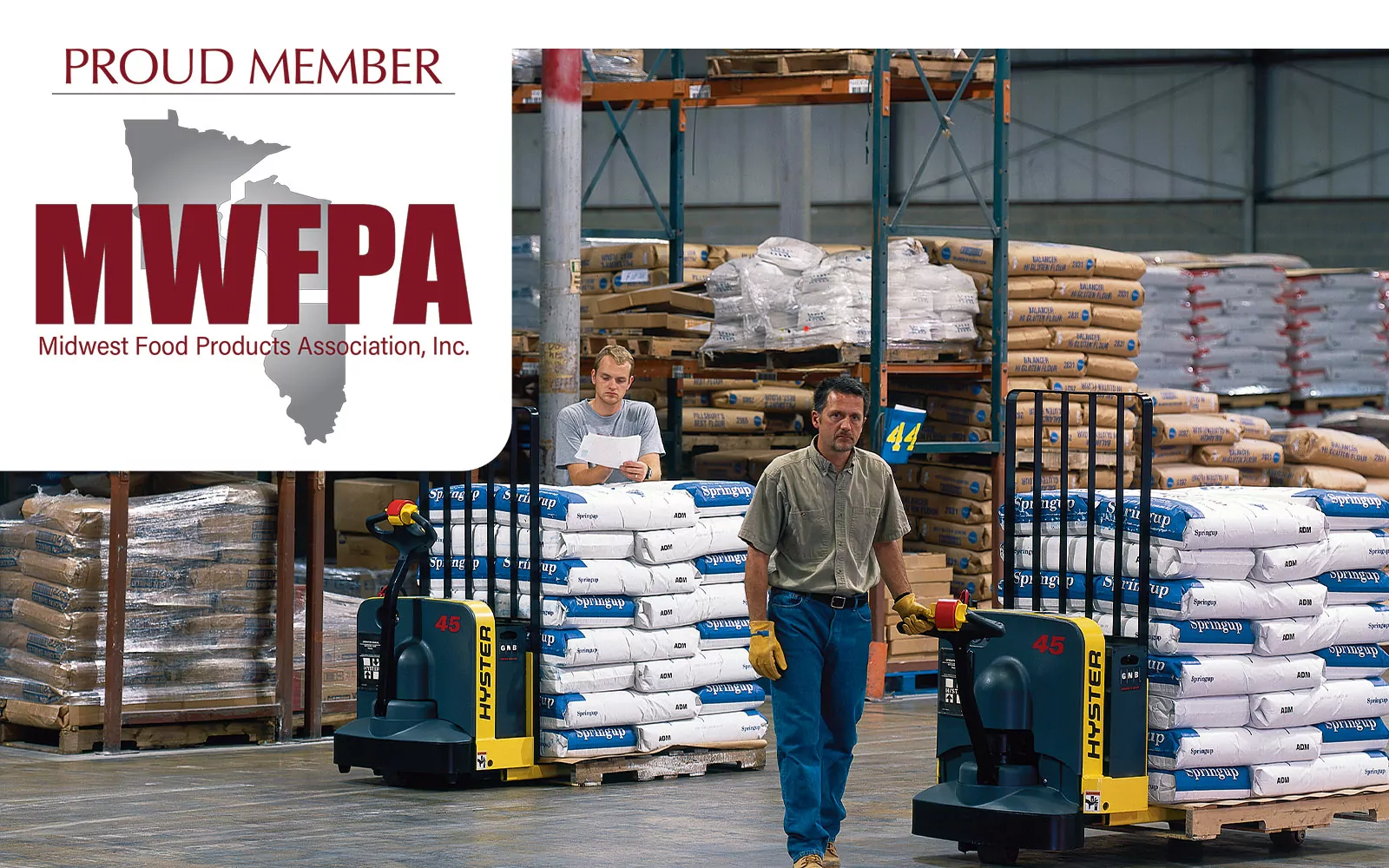 Hyster walkie pallet trucks in a food warehouse with MWFPA logo.