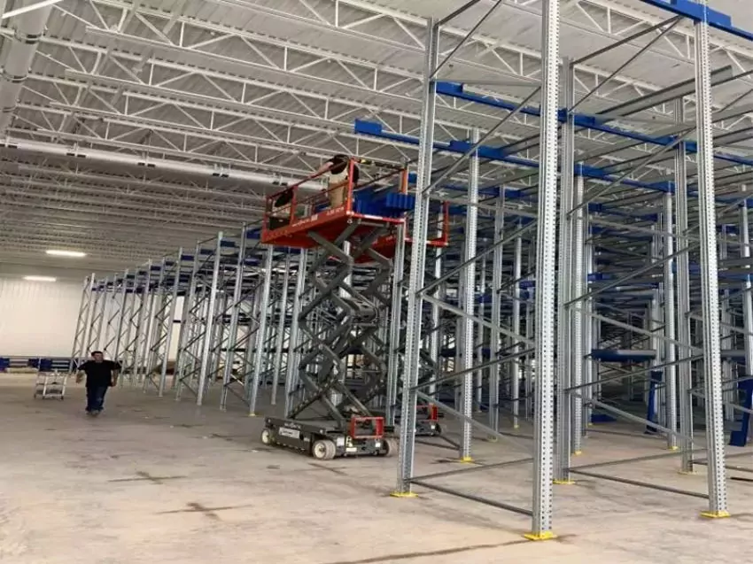 pallet shuttle racking systems being installed inside warehouse.